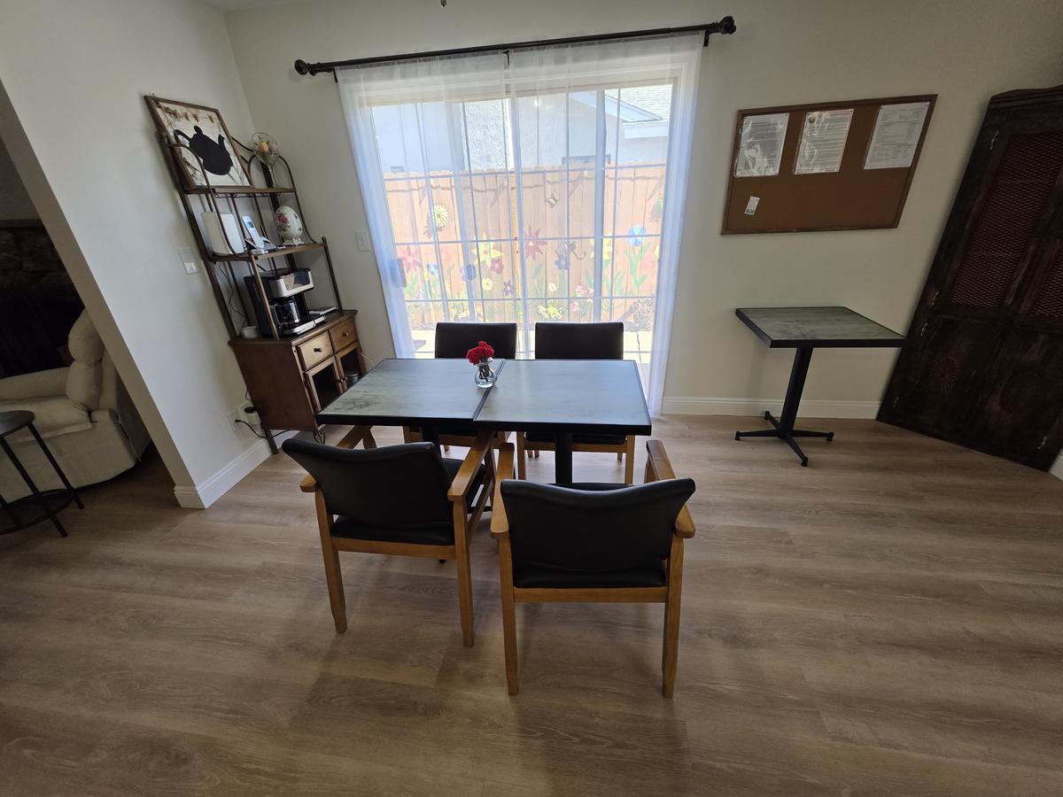 Dining room with a family-style table, chairs and garden view